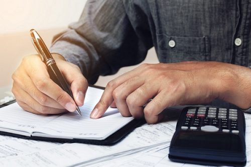 Man writing and make note about cost